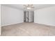 Neutral bedroom showcasing soft carpeting, a ceiling fan, and stairway access for a customizable space at 2409 Thoroughfare Dr. # 2409, North Myrtle Beach, SC 29582