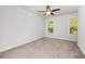 Bright bedroom with plush carpeting, two windows and neutral walls, offering an airy, comfortable ambiance at 2409 Thoroughfare Dr. # 2409, North Myrtle Beach, SC 29582