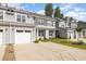 Exterior showcasing multiple gray townhomes with garages and landscaped front yards at 2409 Thoroughfare Dr. # 2409, North Myrtle Beach, SC 29582