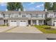Charming townhouse featuring a manicured lawn, two-car garage, and classic architectural details at 2409 Thoroughfare Dr. # 2409, North Myrtle Beach, SC 29582