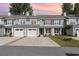 Charming townhouse featuring a manicured lawn, two-car garage, and classic architectural details at 2409 Thoroughfare Dr. # 2409, North Myrtle Beach, SC 29582