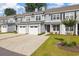 Exterior view of townhomes featuring attached garages, sidewalks, and landscaping at 2409 Thoroughfare Dr. # 2409, North Myrtle Beach, SC 29582