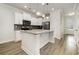Bright kitchen featuring white cabinets, gray backsplash, stainless appliances, granite counters and an island with pendant lighting at 2409 Thoroughfare Dr. # 2409, North Myrtle Beach, SC 29582