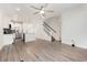 Open-concept living room with kitchen, staircase, and stylish gray flooring at 2409 Thoroughfare Dr. # 2409, North Myrtle Beach, SC 29582