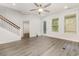 Open living room with staircase, neutral color palette, ceiling fan, and stylish gray flooring at 2409 Thoroughfare Dr. # 2409, North Myrtle Beach, SC 29582