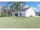 Back of house with large yard, screened porch, and exterior access to the garage at 250 Ole Maple St., Loris, SC 29569