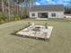 Aerial view of backyard featuring a fire pit area and spacious lawn at 250 Ole Maple St., Loris, SC 29569