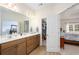 Well-lit bathroom with a double vanity, wood grain floors, and entry to another room at 250 Ole Maple St., Loris, SC 29569