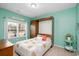 Comfortable bedroom featuring a Murphy bed and a vibrant mint accent wall at 250 Ole Maple St., Loris, SC 29569