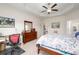 Spacious bedroom featuring a ceiling fan, tray ceilings, and dedicated desk area at 250 Ole Maple St., Loris, SC 29569