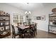 Charming dining room with a wooden table, six chairs, and a window with natural light at 250 Ole Maple St., Loris, SC 29569