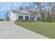 Charming white home featuring a well-manicured lawn, a concrete driveway, and classic black shutters at 250 Ole Maple St., Loris, SC 29569