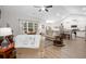 Bright, open living space with hardwood floors, a ceiling fan, and a view of the kitchen at 250 Ole Maple St., Loris, SC 29569