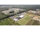 Aerial view featuring community amenities, including sports fields, school, and parking, nestled within a natural landscape at 2825 Mcdougall Dr., Conway, SC 29526