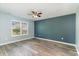 Spacious bedroom with wood flooring, neutral tones, and a bright window view at 2825 Mcdougall Dr., Conway, SC 29526