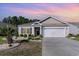 Charming single-story home with a well-manicured lawn, blue shutters, and a two-car garage at 2825 Mcdougall Dr., Conway, SC 29526