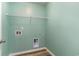 Laundry room with hookups and overhead storage shelf on a clean, mint-green wall at 2825 Mcdougall Dr., Conway, SC 29526