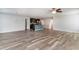 Bright open-concept living area with wood-look flooring connecting to the kitchen and other living spaces at 2825 Mcdougall Dr., Conway, SC 29526