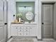 Stylish bathroom featuring a white vanity with framed mirror and a neutral green accent wall at 2858 Ellesmere Circle, Myrtle Beach, SC 29579