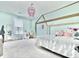 Charming bedroom with a playhouse-style bed frame, pink chandelier, and delightful decor creating a cheerful space at 2858 Ellesmere Circle, Myrtle Beach, SC 29579