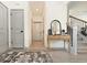 Inviting hallway features hardwood floors, grey doors, console table with mirror and stairs at 2858 Ellesmere Circle, Myrtle Beach, SC 29579