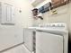 Functional laundry room featuring a washer, a dryer, and wire shelving at 2858 Ellesmere Circle, Myrtle Beach, SC 29579