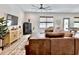 Inviting living room featuring a leather sofa, ceiling fan, and neutral decor, ideal for comfortable lounging and entertaining at 2858 Ellesmere Circle, Myrtle Beach, SC 29579