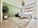 Bright main bedroom with decorative chandelier, neutral walls, and large window overlooking the manicured lawn at 2858 Ellesmere Circle, Myrtle Beach, SC 29579