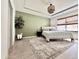 Serene main bedroom with a tray ceiling, decorative chandelier, and a large window providing ample natural light at 2858 Ellesmere Circle, Myrtle Beach, SC 29579