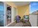 View of an outside balcony with comfortable furniture and sliding glass doors to the living room at 301 N Waccamaw Dr. # 110, Murrells Inlet, SC 29576