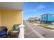 View from the outside balcony overlooking a neighborhood street with neighboring beach houses at 301 N Waccamaw Dr. # 110, Murrells Inlet, SC 29576