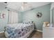 Bright bedroom featuring a ceiling fan, stylish mirror, and coastal themed bedding at 301 N Waccamaw Dr. # 110, Murrells Inlet, SC 29576