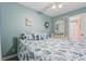 Bright bedroom featuring a ceiling fan, stylish mirror, and coastal themed bedding at 301 N Waccamaw Dr. # 110, Murrells Inlet, SC 29576