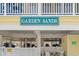 Exterior shot showing Garden Sands signage and parking garage at 301 N Waccamaw Dr. # 110, Murrells Inlet, SC 29576