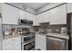 Kitchen featuring stainless steel appliances, stone countertops, and white cabinetry at 301 N Waccamaw Dr. # 110, Murrells Inlet, SC 29576
