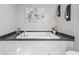 Bathroom featuring a modern bathtub with sleek fixtures and stylish wall decor at 3175 Lyndon Dr., Little River, SC 29566