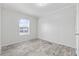 Bright bedroom with a view, light gray walls, and light gray vinyl flooring at 3175 Lyndon Dr., Little River, SC 29566
