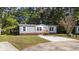 Charming single-story home with vinyl siding, brick foundation, and a concrete driveway at 3175 Lyndon Dr., Little River, SC 29566