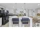 A stylish kitchen features white cabinets, an island with chairs, and an adjacent dining area at 3175 Lyndon Dr., Little River, SC 29566