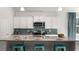 Well-equipped kitchen featuring a large island with seating, white cabinets, and a stylish backsplash at 325 Wingspan Ct., Myrtle Beach, SC 29588