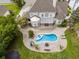 Aerial view of a home with a lagoon pool, firepit, patio, and lush greenery in the backyard at 3564 Brampton Dr., Myrtle Beach, SC 29588