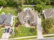 Aerial view of a residence featuring lush lawn, mature trees, and ample driveway parking at 3564 Brampton Dr., Myrtle Beach, SC 29588