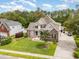 Aerial view showcasing a meticulously landscaped two-story home with a brick facade, driveway, and lush green lawn at 3564 Brampton Dr., Myrtle Beach, SC 29588