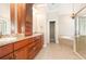 Bathroom featuring dual sinks with granite counters, vanity storage, and separate shower and soaking tub at 3564 Brampton Dr., Myrtle Beach, SC 29588