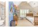 Playful bedroom featuring vibrant blue accent wall, natural light, carpet flooring and ensuite bathroom at 3564 Brampton Dr., Myrtle Beach, SC 29588