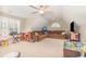 Spacious bonus room with ample seating, natural light, ceiling fan, and entertainment center at 3564 Brampton Dr., Myrtle Beach, SC 29588