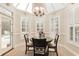 Bright breakfast nook with skylight, plantation shutters, and tile flooring provides an elegant space for dining at 3564 Brampton Dr., Myrtle Beach, SC 29588