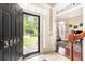 Inviting foyer with tiled flooring, a visible living room, and an exterior view through the front door at 3564 Brampton Dr., Myrtle Beach, SC 29588