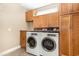 Well-organized laundry room with built-in cabinets, granite counters, and sink maximizes functionality and space at 3564 Brampton Dr., Myrtle Beach, SC 29588