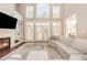 Bright living room featuring high ceilings, a fireplace, built-in shelving, hardwood floors, and large windows for ample sunlight at 3564 Brampton Dr., Myrtle Beach, SC 29588